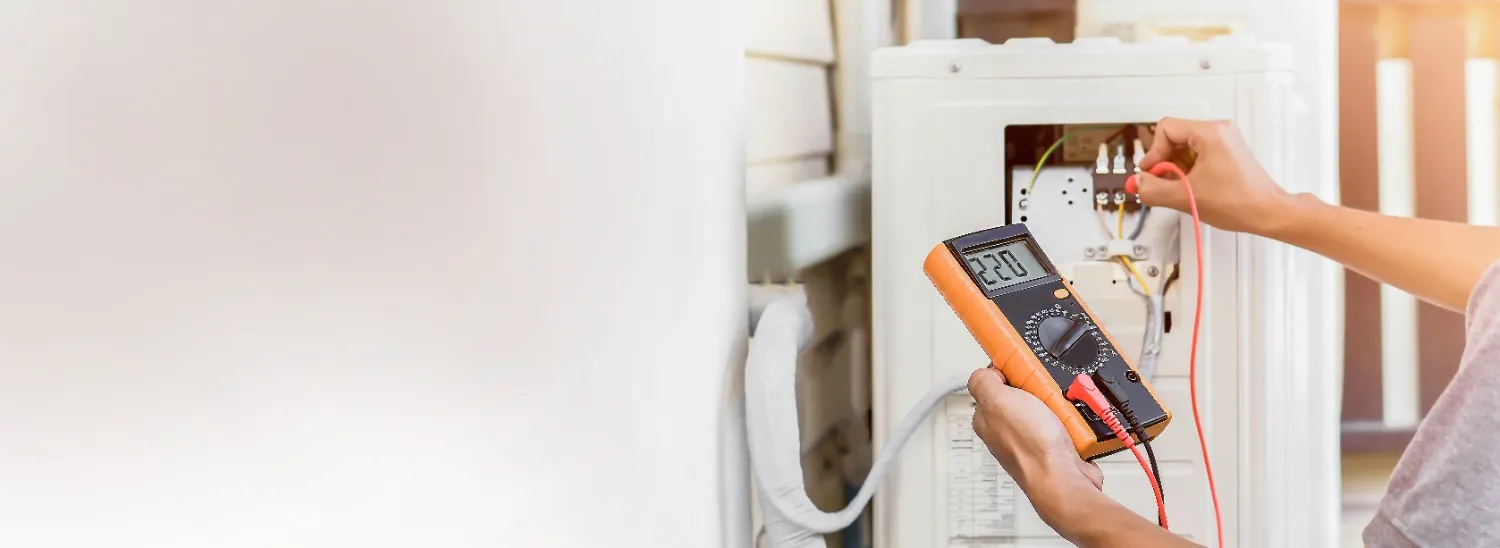 Technician testing a heating unit with a multimeter